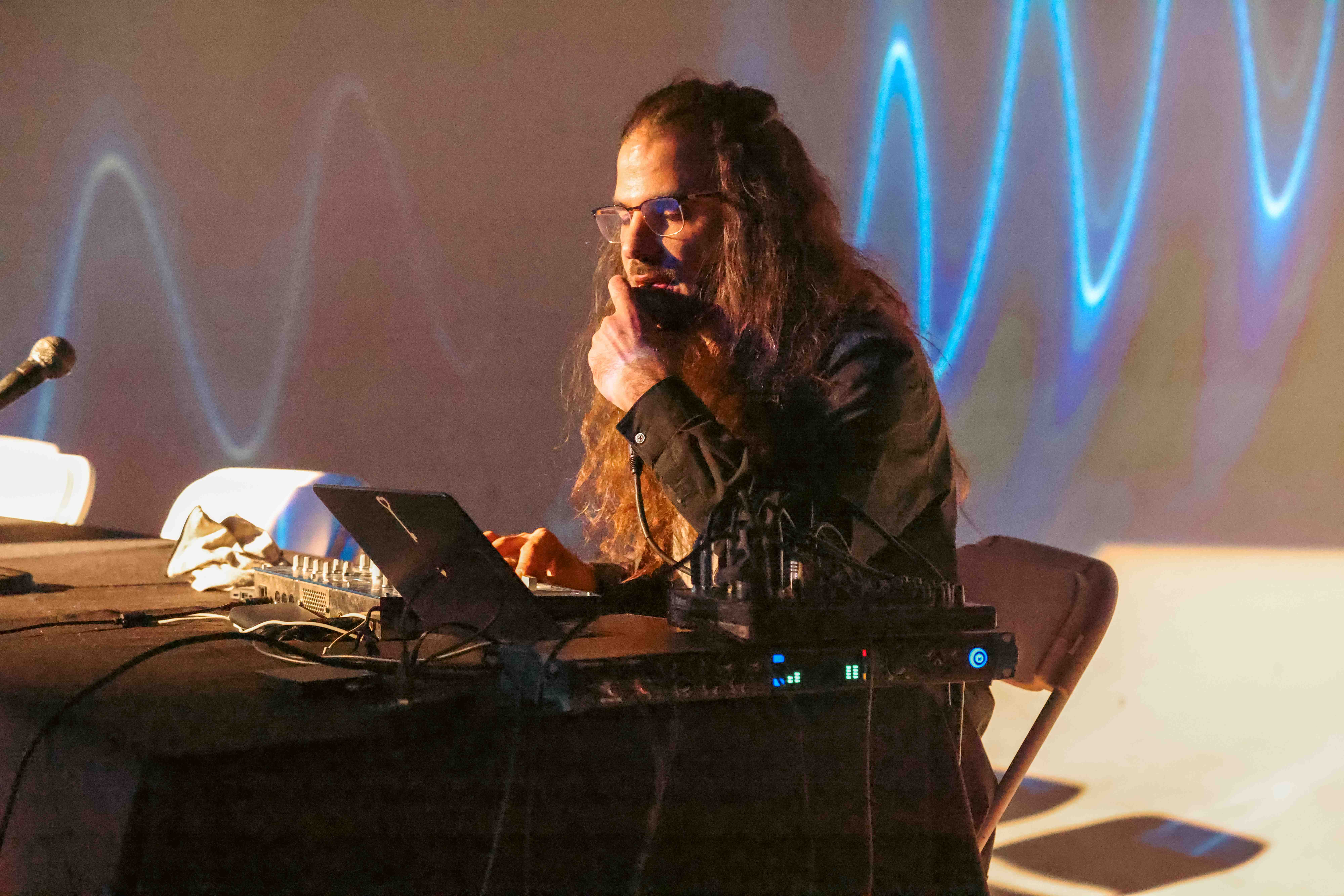 Torkom Ji performing live with wave projections