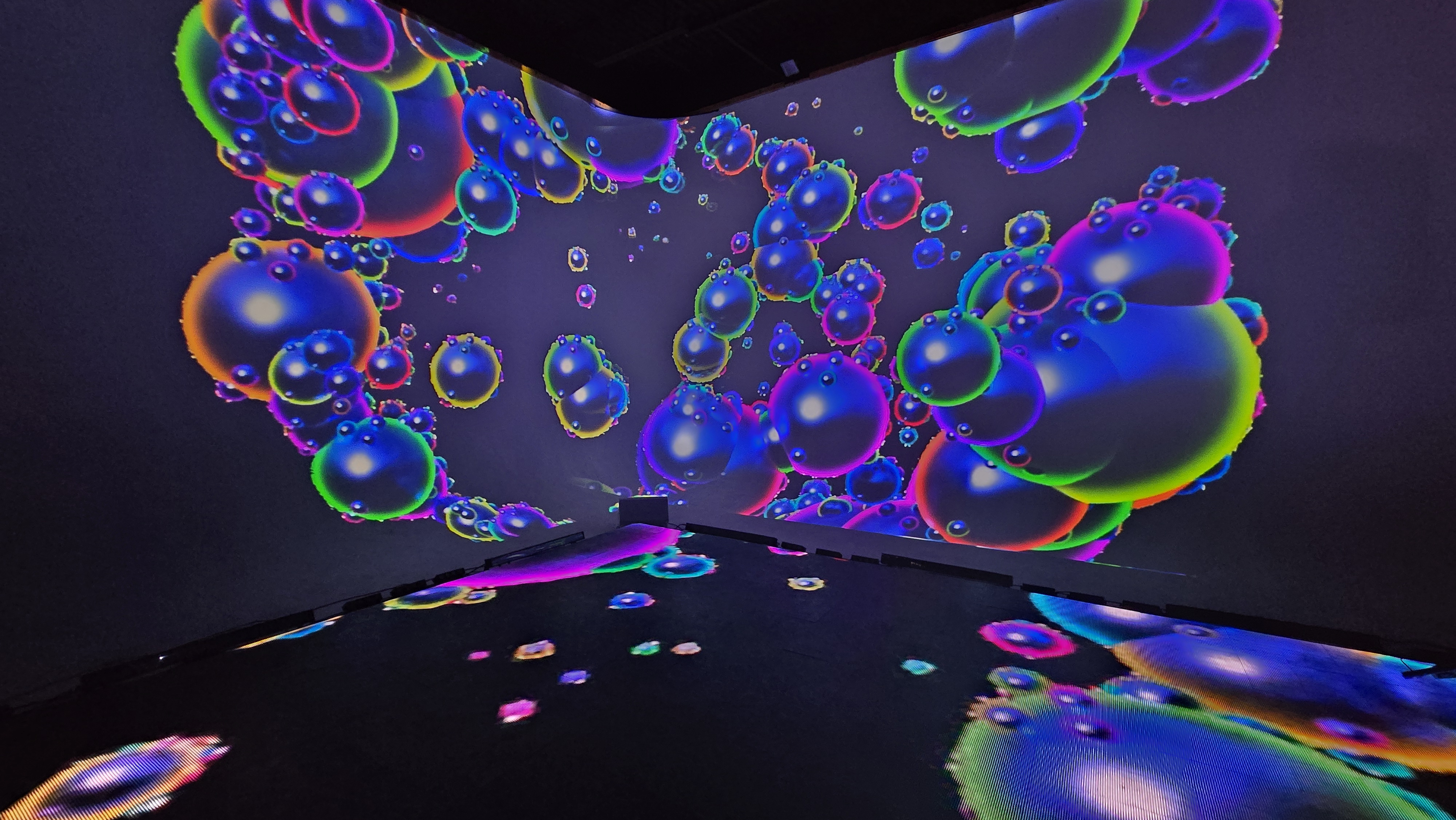 Iridescent bubbles floating across projection wall