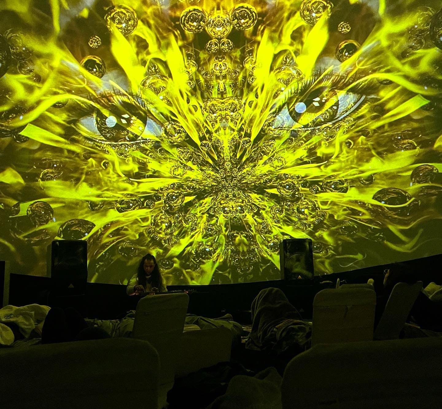 Golden fractal visuals projected across the dome during live performance