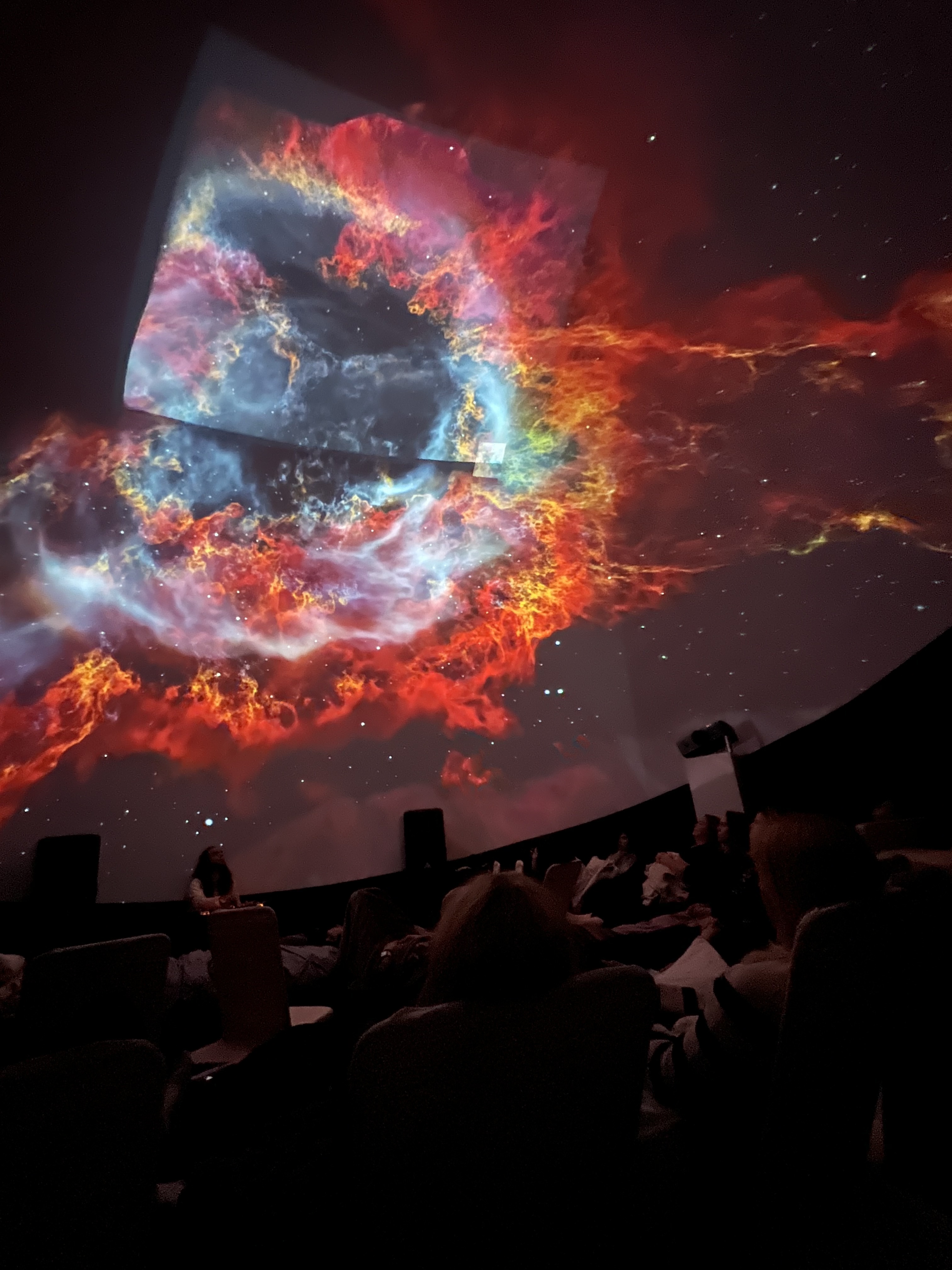 Red nebula and cosmic projections wrapping the dome surface